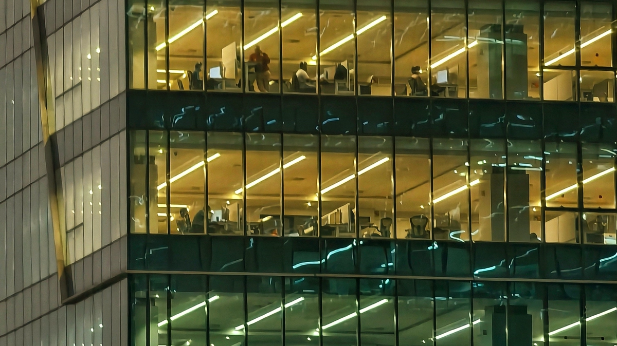 Modern office building with illuminated workspaces