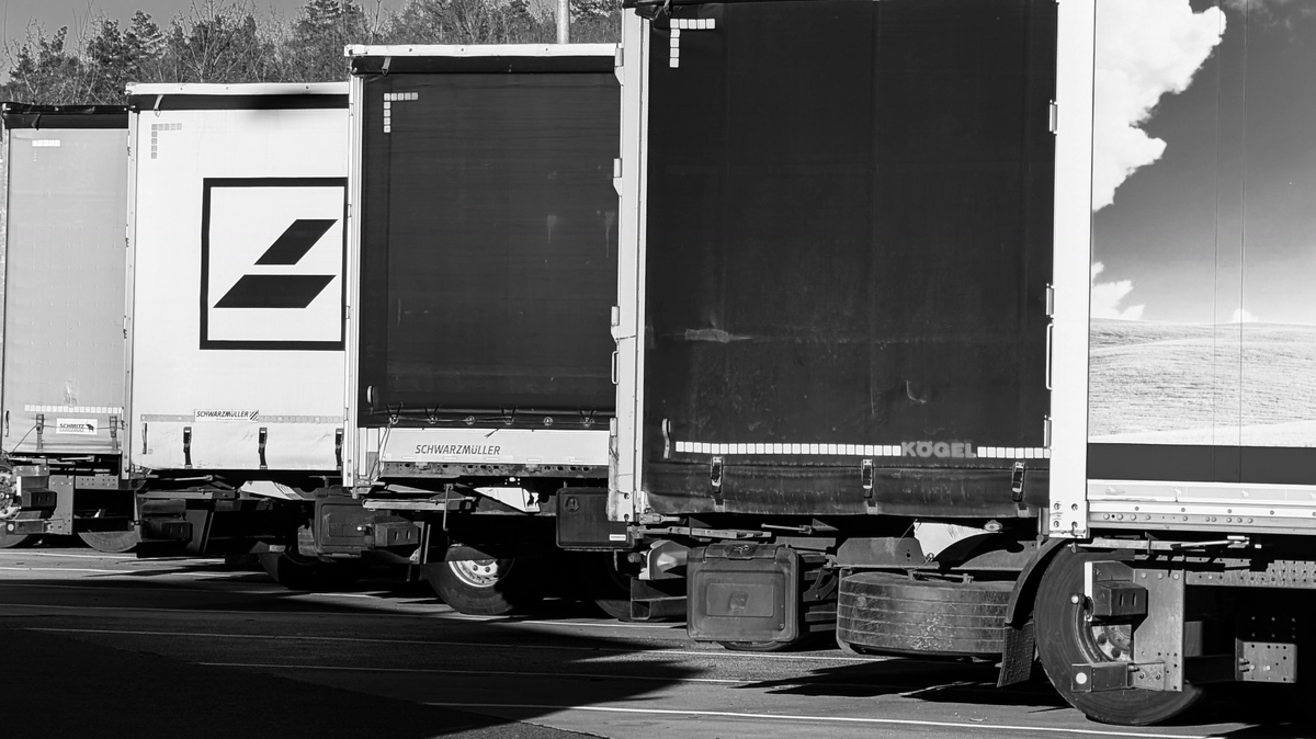 Line of commercial trucks at a transport yard